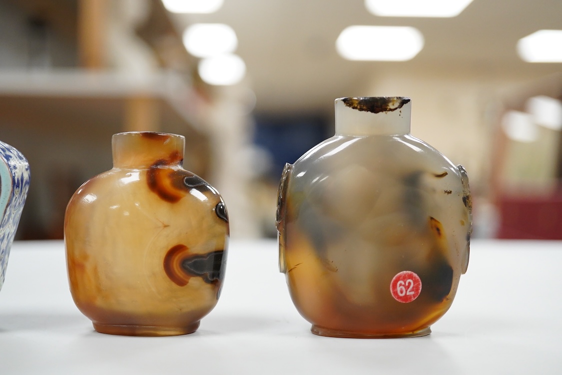 Three 19th century Chinese agate snuff bottles and a porcelain snuff bottle, largest 6cm high (4)